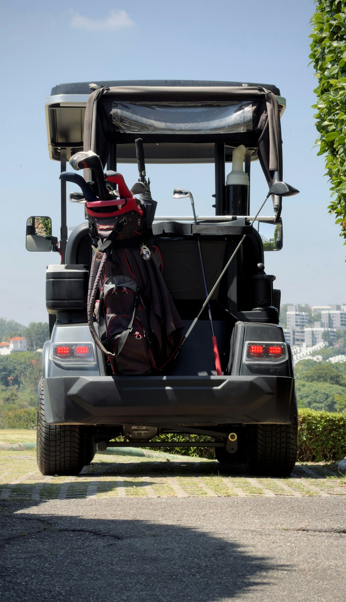 Golf cart with equipment bags ready for collection
